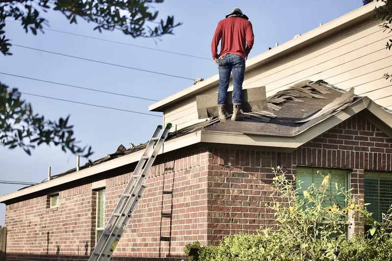 Professional roofer working on a residential roof in Sunridge